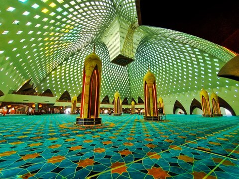 Bandung City, Indonesia - July 08, 2026: Magnificent interior architecture of Al-Jabbar Grand Mosque with a unique geometric roof pattern and a turquoise golden patterned carpet.