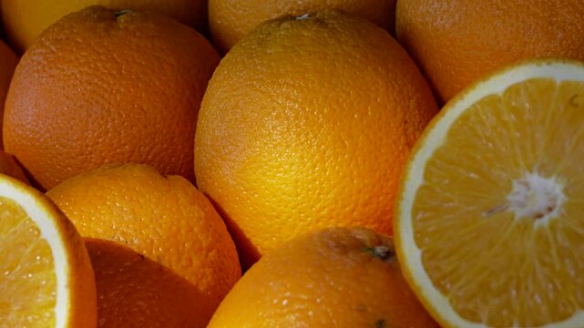 Pile of Fresh Ripe Whole and Cut Oranges