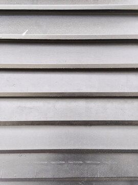 Horizontal shiplap wood wall texture in dark charcoal gray color with fine wood grain neatly arranged giving a modern impression