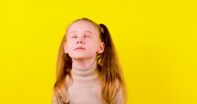 Video of a young schoolgirl eagerly raising her hand to answer, then rolling her eyes after not being chosen. Concept of classroom participation, learning, impatience, disappointment, and childhood