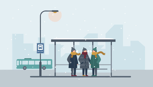 Group of people wearing warm winter clothes standing and waiting for a bus at a snowy city bus stop in winter.