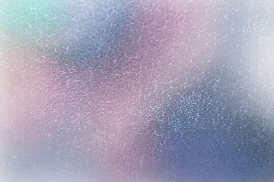 Abstract minimalist frosted glass background with colorful iridescent holographic gradient and hammered ice texture pattern
