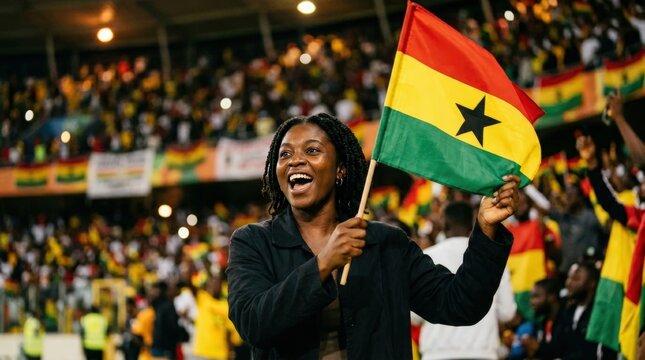 Ghanaian football supporter cheering with national flag at stadium