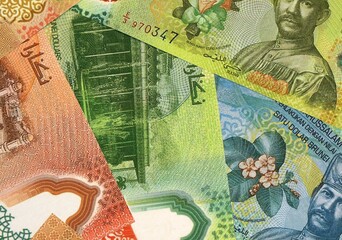 Brunei Darussalam dollar money bills in pile on table. Brunei BND currency cash close up © Viktor