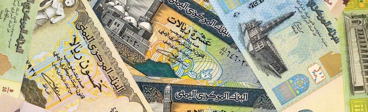 Yemeni rial money bills in pile on table. Yemen YER currency cash close up