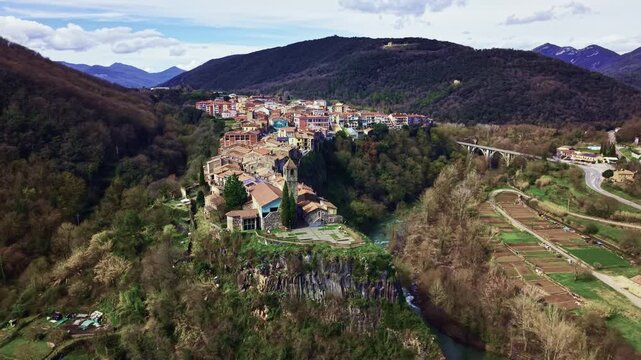 Historic church and cliff edge village of Castellfollit de la Roca from drone