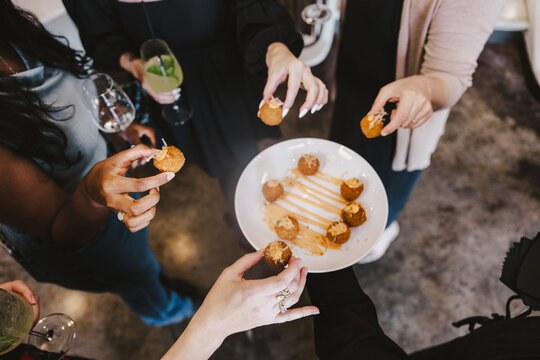 Hands Reaching for Passed Appetizer