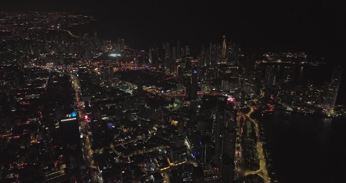 Panama City Aerial v92 birds eye view flyover and around downtown urban neighborhoods capturing illuminated streets and modern lavish cityscape at night - Shot with Mavic 3 Cine - April 2022
