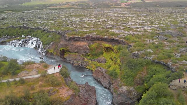 Hraunfossar Waterfalls, Iceland. Aerial view from drone on a summer day. Slow motion
