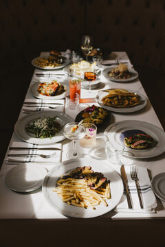Restaurant Table with Food and Cocktails