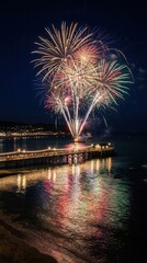 Fototapeta premium A Breathtaking Night Scene Featuring Vibrant Fireworks Exploding Over a Coastal Pier and Reflecting on the Calm Ocean Waters During a Festive Summer Celebration
