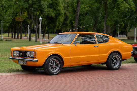 Ford Taunus GT TC1 Coupe 1970s - front three quarter view of a classic vintage orange oldtimer car parked on a walkway in Palic, Serbia on July 5, 2026.