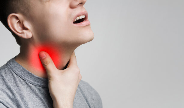 Man with thyroid gland problem, touching his neck, closeup, panorama, empty space