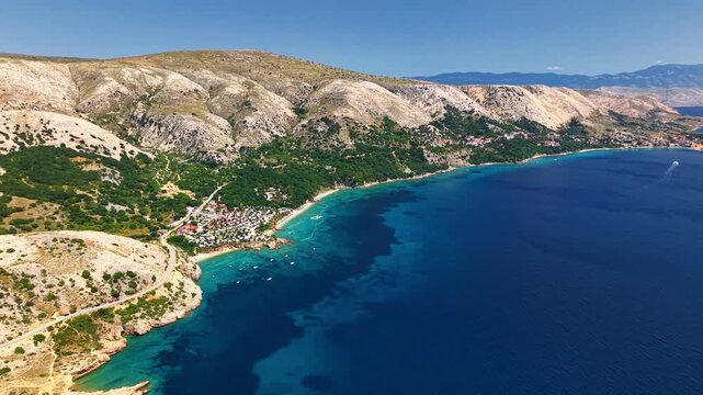 Aerial panorama of seaside campsite and turquoise Adriatic coast on Krk island, Croatia. Summer camping and outdoor vacation lifestyle concept