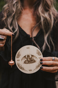 Woman Holding Pendulum
