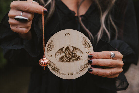 Woman Holding Pendulum