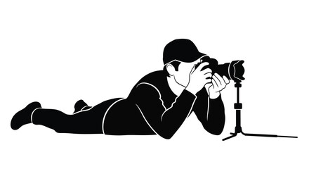Lying photographer with camera on tripod black and white graphic silhouette photography tripod prone shooting capture image visual monochrome minimalist © Creativeakash393