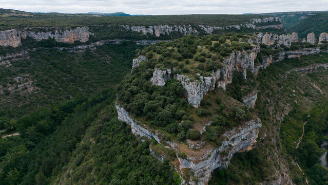 serene canyon landscape with rock formations and lush vegetation in natural outdoor setting viewed from aerial perspective. a breathtaking still scene of nature's beauty.