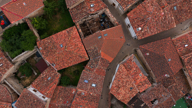 peaceful aerial view of urban residential rooftops with brick and concrete structures in a serene setting, showcasing modern architecture and planning in a vibrant community.
