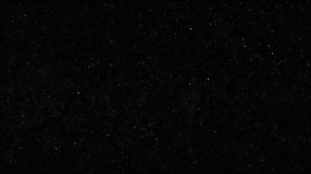 Rising Dust Particles on Black 4K Loop features fine dust particles rising in a black atmosphere in a loop.