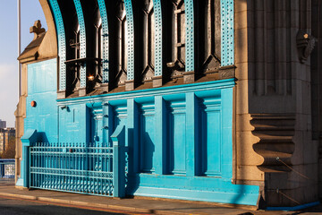 Obraz premium Architectural detail of the blue metal structures and stone pillars on Tower Bridge London