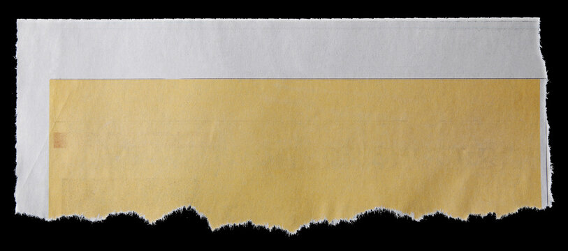 Torn yellow paper piece on black