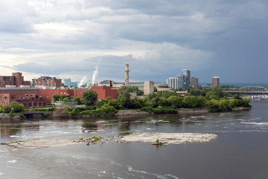 Ottawa River skyline with industrial plant and factory chimney in Gatineau, Quebec.