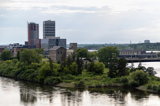 Victoria Island heritage building along waterfront with Gatineau skyline