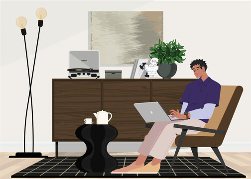A freelancer man works behind a laptop. Coworking space workplace.