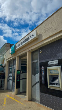 Soulac-sur-Mer, France - June 07, 2026. View of the BNP Paribas Bank branch exterior with ATM Cash Services and sand on the Sidewalk.