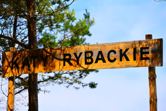 Wooden Polish Sign with Katy Rybackie Text in Forest Environment