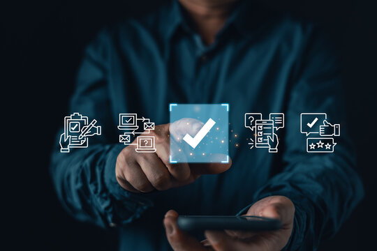 Man touching a digital checkmark hologram with customer feedback and survey icons. Concept of online rating, user experience, satisfaction, quality assessment, and digital questionnaire.