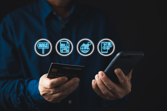 Man holding credit card and smartphone with glowing e-commerce icons. Concept of online shopping, digital payment, global retail, mobile banking, internet transaction, and sale event.