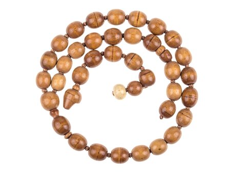 A spiral arrangement of polished, variegated brown beads on a white background