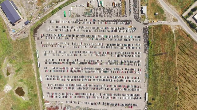 Aerial view of a car impound lot with damaged cars after an accident or towed for illegal parking.