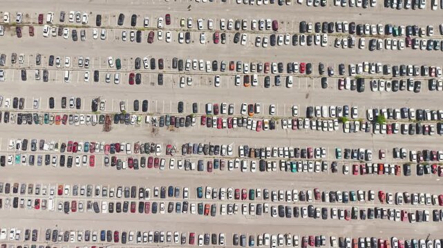 Aerial view of a car impound lot with damaged cars after an accident or towed for illegal parking.