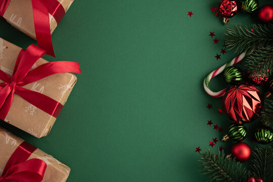 Christmas gifts and decorations on green background with copy space