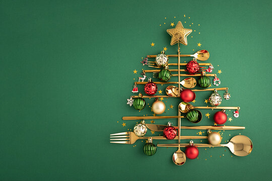 Golden cutlery creating a christmas tree with festive decorations