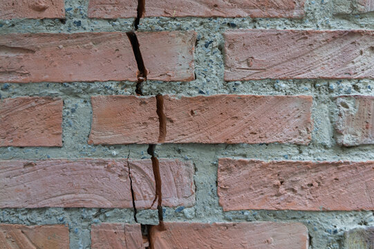 Severe vertical structural crack in an old brick wall, foundation issue &ndash; background texture
