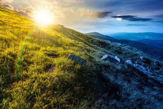mountain landscape with grass and rock on a slope. day meet night. view in to the distant valley of carpathian mountains. sun and moon in harmony over mountainous scenery of ukraine on summer solstice