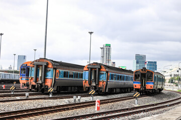 diesel multiple unit or Diesel Railcar on the railroad tracks heading towards the City, outdoor landscape. © MMxeon