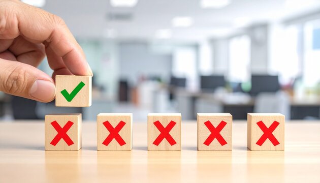 Hand lifting green check cube above red X cubes symbolizing correct choice, success, and decision‑making.
