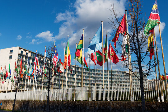 Paris, France - March 15, 2026 : Flags fluttering in the wind in front of the UNESCO (United Nations Educational, Scientific and Cultural Organization) headquarters at place de Fontenoy in Paris.