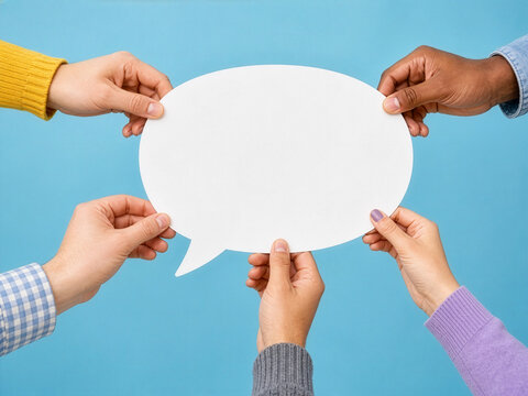 Diverse Hands Holding Blank White Speech Bubble Cutout Together on Blue Background for Communication, Teamwork, and Social Media Concept