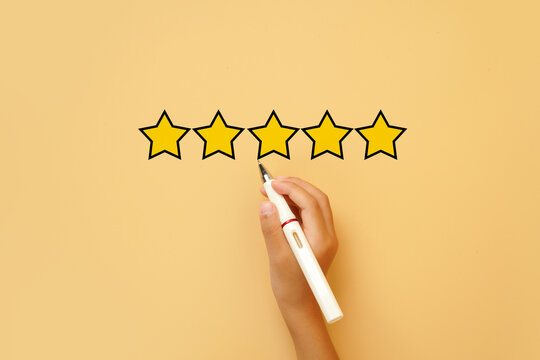 Hand drawing a five star rating on a bright background. Concept of customer satisfaction, excellent review, quality service, top rating and positive feedback.