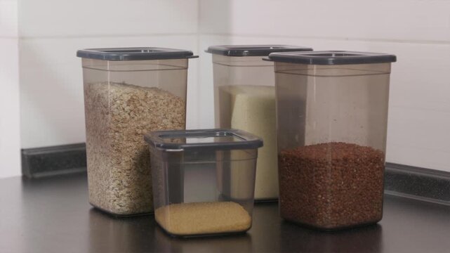 Adding a plastic container with couscous to a kitchen storage set