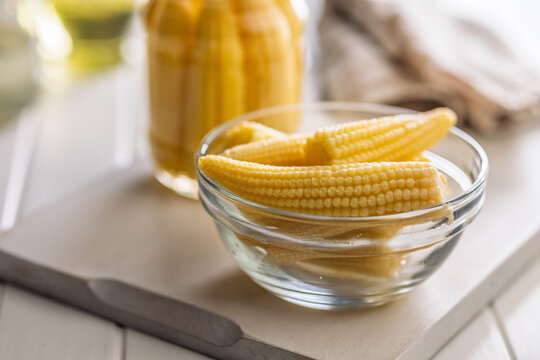 Fresh Baby Corn In Glass Bowl With Jar On Kitchen Countertop, Yellow Vegetable Snack Ingredients