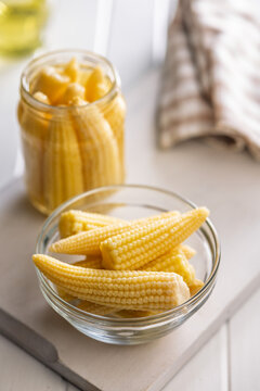 Fresh Baby Corn In Glass Bowl With Jar On Kitchen Countertop, Yellow Vegetable Snack Ingredients