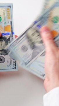 Male hands counting US Dollar bills, close-up
