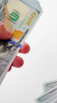 Male hands counting US Dollar bills, close-up